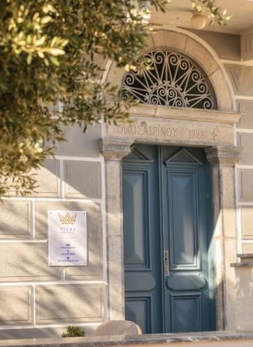 a blue door on a building with a sign on it at STEMA Kalymnos in Kalymnos
