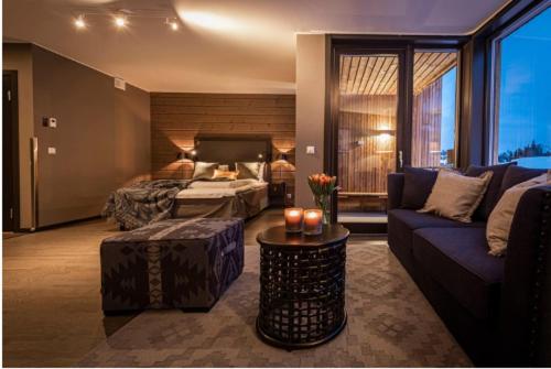 a living room with a bed and a couch at Skistar Lodge Hemsedal in Hemsedal
