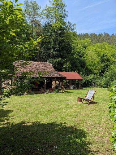a bench sitting in the grass in front of a building at Eco Lodge Gradac in Popare