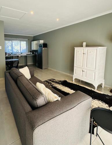 a living room with a couch and a kitchen at Robyns Nest Self Catering Studio Cottage No2 in Kloof