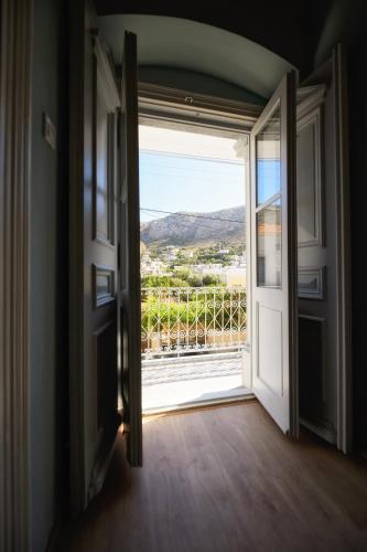 an open door to a balcony with a view at STEMA Kalymnos in Kalymnos