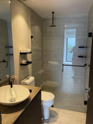 a bathroom with a sink and a toilet and a shower at Fantastic designer apartment, beachfront! in Bucerías