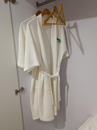 a group of white towels hanging on a door at Baan Plaifah Khao Yai Hotel in Khao Yai