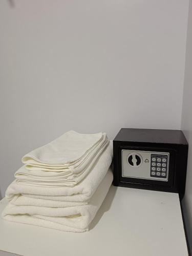 a pile of towels sitting next to a microwave at Baan Plaifah Khao Yai Hotel in Khao Yai