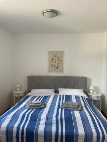 uma cama azul e branca com duas toalhas em MeerLeev - Panoramablick em Schillig