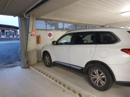 a white car is parked in a garage at Apartmán Vratička Říčky v Orlických horách in Říčky