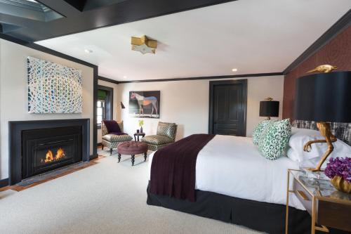 a bedroom with a king sized bed and a fireplace at The Merchant in Salem