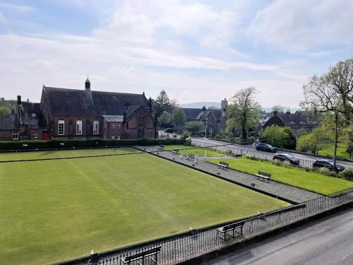 a large tennis court in front of a house at Pass the Keys Beautiful House With Stunning Views Kirkcudbright in Kirkcudbright
