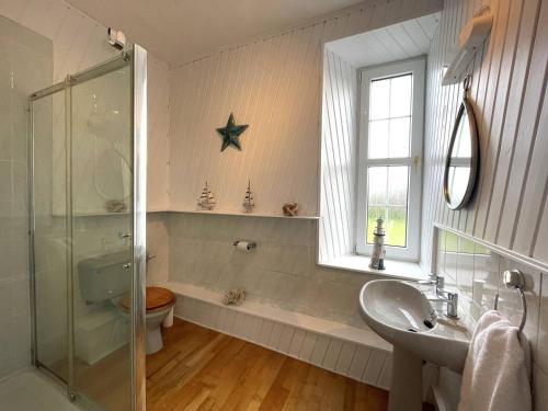 a bathroom with a sink and a shower and a toilet at Pass the Keys Beautiful House With Stunning Views Kirkcudbright in Kirkcudbright