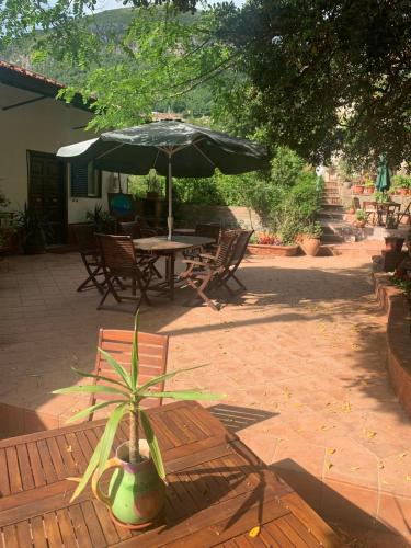 a patio with an umbrella and a table and chairs at the secret garden in Vietri sul Mare