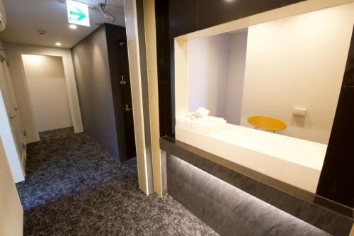 a bathroom with a sink and a mirror at smart room tokyo koiwa city in Tokyo