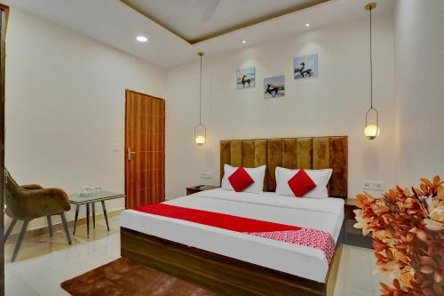 a bedroom with a bed and a table and a chair at Flagship Hotel Orchid in Ludhiana