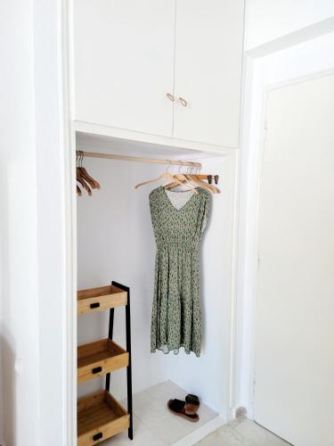 a dressing room with a dress hanging in a closet at Kalimera Studios and Apartments in Moraitika