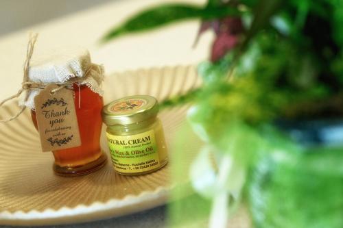 two jars of honey sitting on a plate at STEMA Kalymnos in Kalymnos