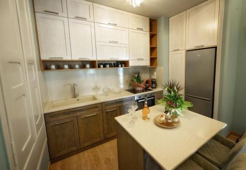 a kitchen with white cabinets and a counter top at STEMA Kalymnos in Kalymnos