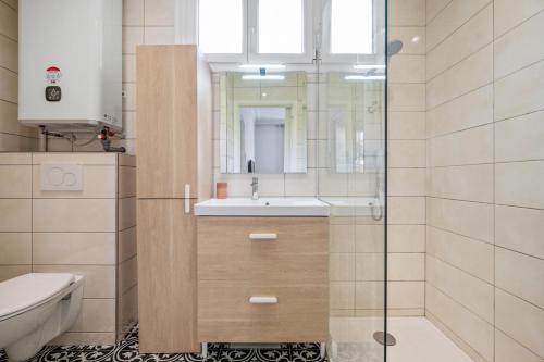 a bathroom with a toilet and a sink and a mirror at Pink Palace - Quartier Authentique Libération in Nice