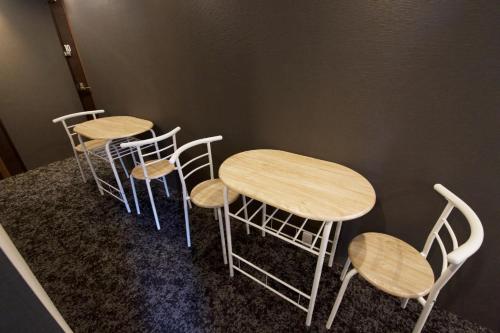a group of tables and chairs in a room at smart room tokyo koiwa city in Tokyo
