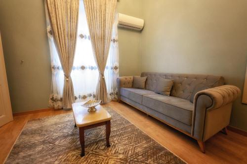 a living room with a couch and a table at STEMA Kalymnos in Kalymnos