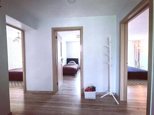 a room with two mirrors and a room with a bed at Cozy 3 bedroom apartament in town centre of Joniškis in Joniškis