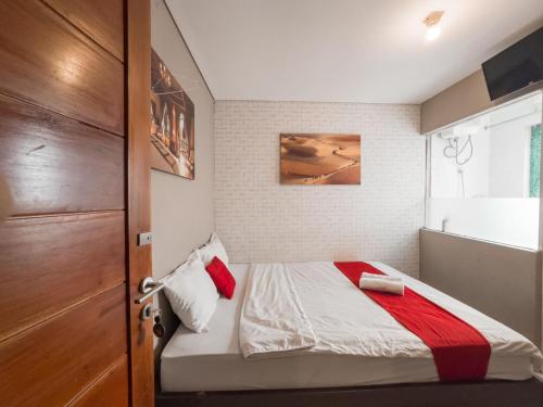 a small bedroom with a bed and a window at Beranda Plus near Hayam Wuruk 2 in Jakarta