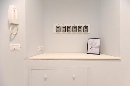 a shelf above a door with a phone on it at Bianca Elegance Rooms in La Spezia