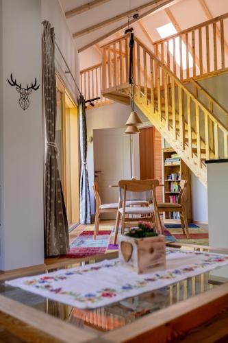 a living room with a staircase and a table at Cottage Bad Ischl in Bad Ischl
