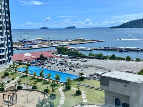 a view of a resort with a pool and the ocean at JQ1 SEA & POOL or CITY View WIFI I WASHING MACHINE for Some Units I CUCKOO WATER Jesselton Quay by R2 in Kota Kinabalu