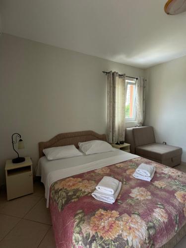 a bedroom with a bed with two towels on it at Villa Ivanovic in Budva