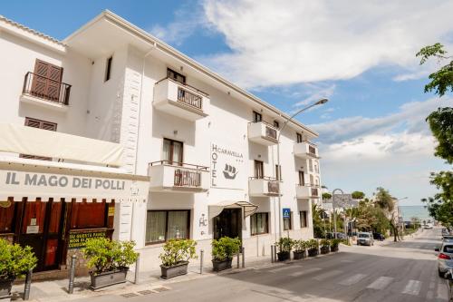 a white building on the side of a street at Hotel La Caravella in Vieste