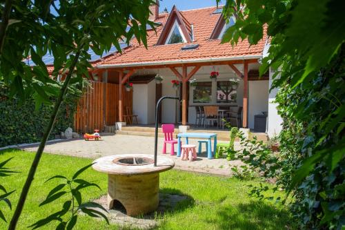 a house with a bird bath in the yard at Tokaj Family Apartment in Tokaj