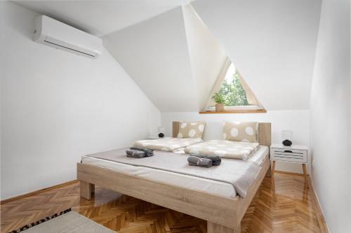 a bedroom with a bed with two bags on it at Tokaj Family Apartment in Tokaj