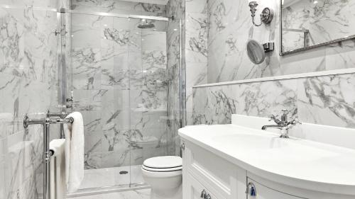a bathroom with a toilet and a sink and a shower at Matfen Hall Hotel, Golf & Spa in Matfen