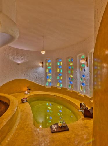 a bathroom with a green tub in a room at The Earth at Ranthambore in Sawāi Mādhopur