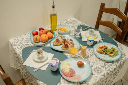 a table with plates of breakfast food on it at Hotel La Caravella in Vieste
