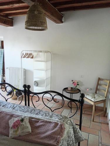 a bedroom with a bed and a table and a chair at Casale - La Camera di Leda in Lamporecchio