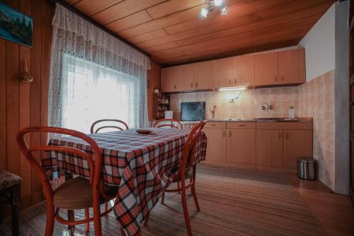 a kitchen with a table and chairs in a room at Kuca Lula Stara planina in Pirot