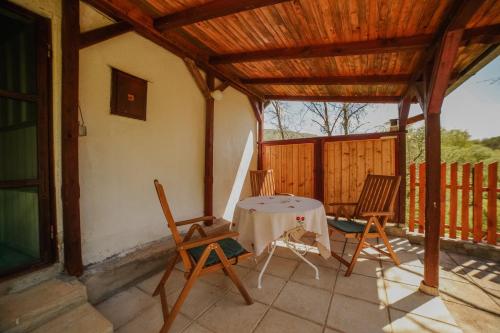 a patio with two chairs and a table on a porch at Kuca Lula Stara planina in Pirot