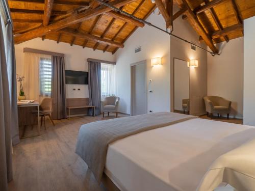 a bedroom with a large bed and a desk at Le Cappuccinelle Suites&SPA in Perugia