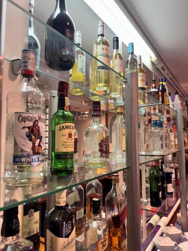 a shelf filled with lots of bottles of alcohol at Geovita w Jadwisinie in Jadwisin