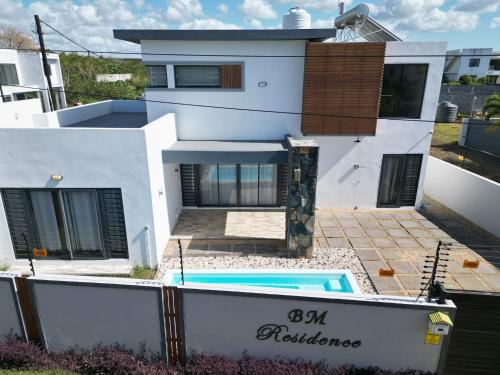a house with a swimming pool in front of it at BM Residence in Grand-Baie