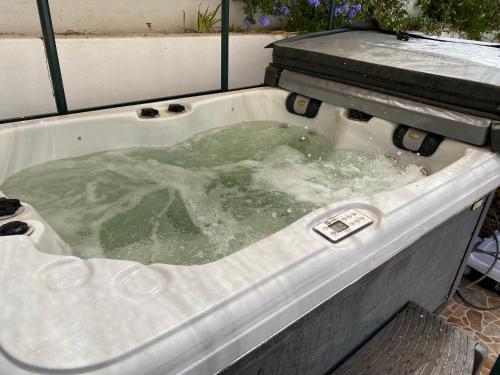 a jacuzzi tub filled with water next to at Luxury Beachfront Villa in La Perla 