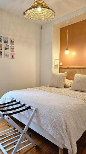 une chambre avec un lit et un lustre dans l'établissement Villa Antonio - Balcon vue mer - Bow-window - Internet Wifi, à Mers-les-Bains