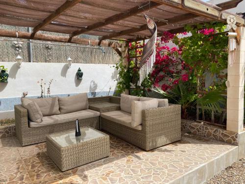 a patio with two couches and a table at Luxury Beachfront Villa in La Perla 