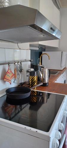 a kitchen with a stove with a frying pan on it at Vita villan in Haparanda