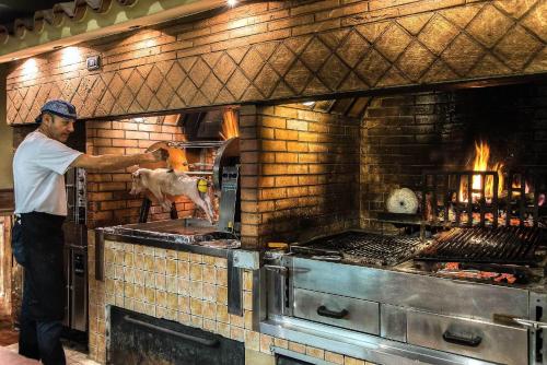 a man is preparing food in an oven at Hotel La Giocca in Rome