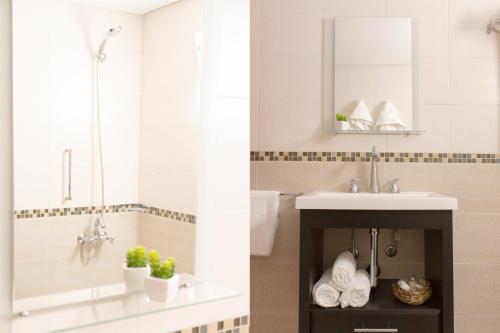 a bathroom with a sink and a mirror at Park View Hotel & Residences in Campana