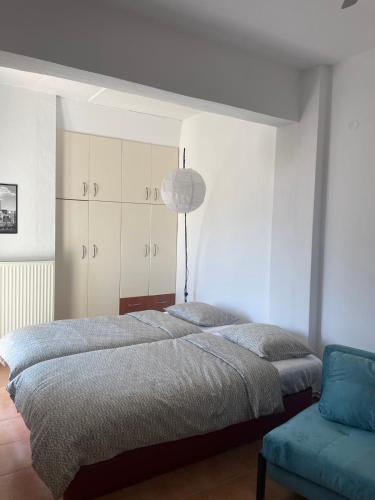a bedroom with a bed and a blue couch at To Rodakino in Litochoro