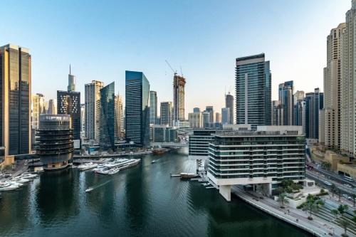 a view of a city with a river and buildings at GuestReady - Comfort Stay l Close To Marina Mall in Dubai