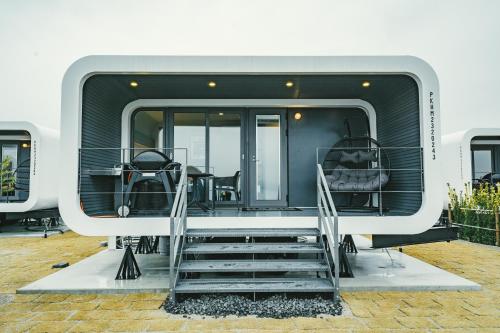 a back end of a rv with stairs and a table at HARIO Beach Walk in Sakihario