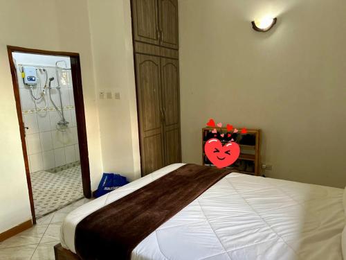 a bedroom with a large bed and a shower at Serenity Space in Kampala